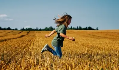 Child running in field