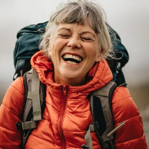Smiling person with camping gear