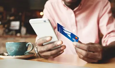Cell phone in one hand and credit card in the other