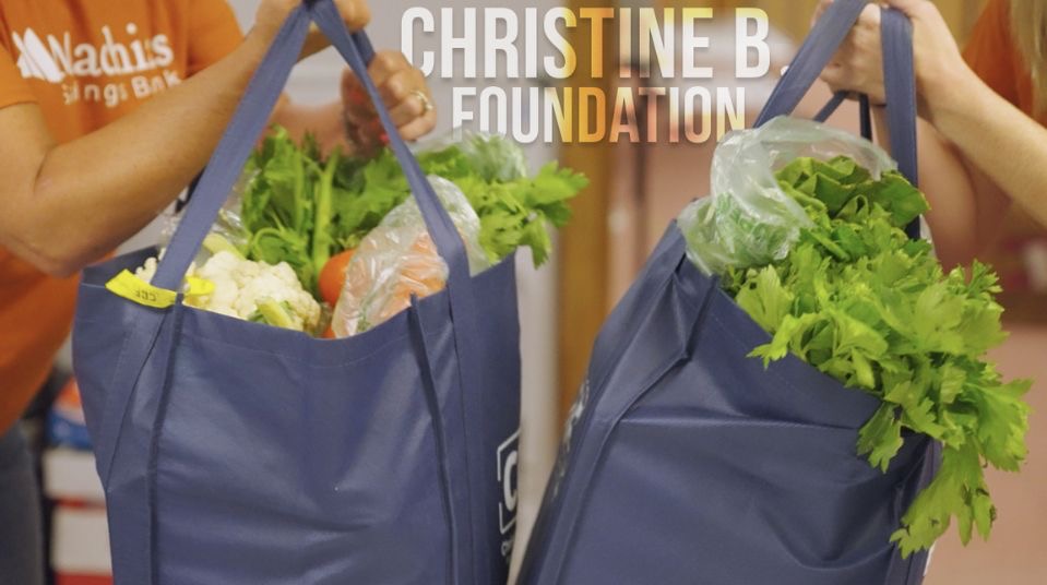 people carrying bags full of fresh produce with the text "Christine B. Foundation"